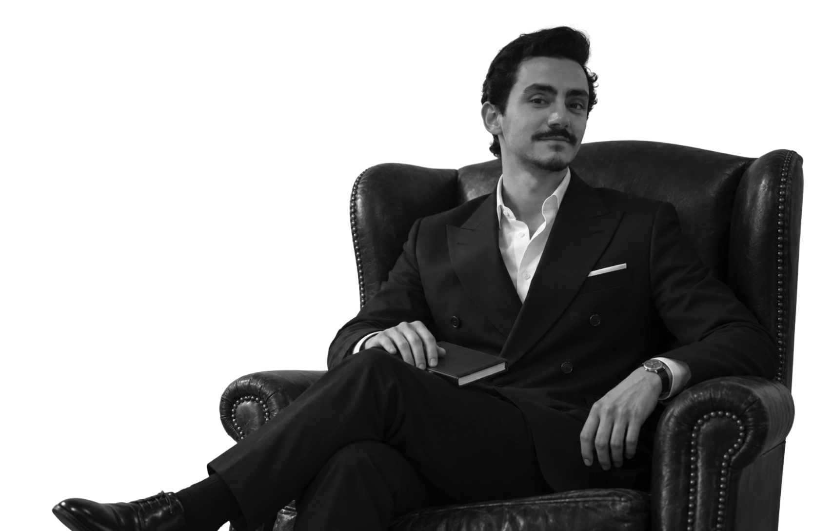 Yusef Nammari seated in a leather wingback chair